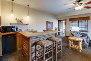 a kitchen with a bar with stools and a couch at Stoney Creek Hotel Sioux City in Sioux City