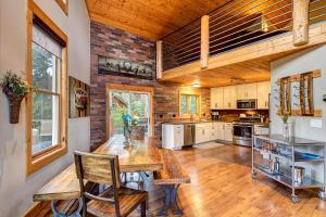 a large kitchen with a wooden table and chairs at Gorgeous updated mountain home just minutes from the slopes, private hot tub, pool table! in Breckenridge