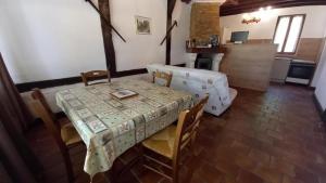 a dining room with a table and a couch at Au bénédit ii in Vielle-Saint-Girons