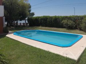 uma grande piscina azul na relva em El rancho de monte em San Miguel del Monte