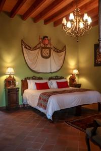 a bedroom with two beds and a chandelier at Casa Don Pascual Hotel Boutique Sweet Home in San Miguel de Allende