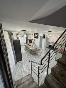 a living room with a table and a dining room at Casa Berbec2 in Dealul Viei