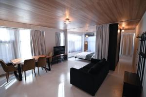 - un salon avec un canapé, une table et un lit dans l'établissement Modern Downtown apartment + FREE parking, à Larissa