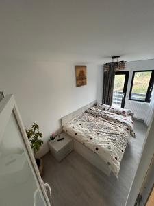 a small bedroom with a bed in a room at Casa Berbec2 in Dealul Viei