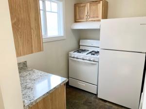 a kitchen with a white stove and a refrigerator at Moose and Maple Lodge in South Lake Tahoe