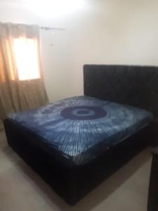 a bed sitting in a room next to a window at Sohna's Paradise Residence 