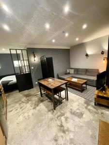 a living room with a couch and a table at Le Repos du Vignoble in Ribeauvillé