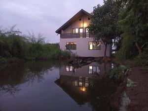 a house sitting next to a body of water at Casa Berbec2 in Dealul Viei