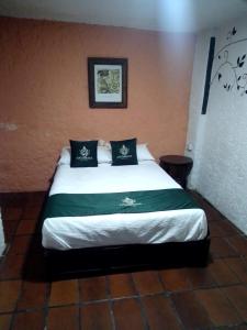 a bedroom with a large bed in a room at Hotel Don Pedro in Puebla