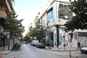 a city street with cars parked on the street at Modern Downtown apartment + FREE parking in Larisa