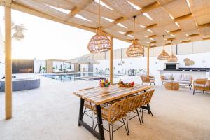 a kitchen and living room with a table and chairs at Nammos Experience in Amman