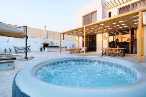 a hot tub in the middle of a patio at Nammos Experience in Amman