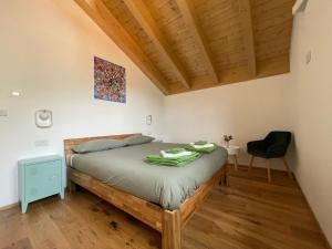 a bedroom with a bed and a chair at I Ciliegi del Conte in Bormio