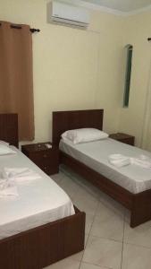 two beds in a hotel room with two bedsskirts at Fogo Morabeza Tur in São Filipe