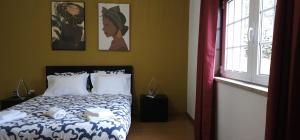 a bedroom with a bed and a window at Panoias Country House in Vila Real