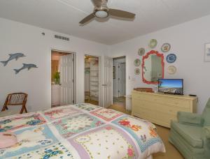 - une chambre avec un lit, une commode et un miroir dans l'établissement Beautifully furnished Beachfront Condo - SR202, à Edgewater
