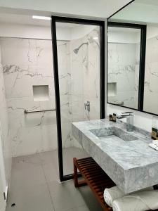 a bathroom with a large marble sink and a shower at Villa Santa Julia in Oaxaca City