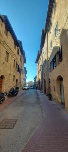 una calle vacía en un callejón entre dos edificios en I' Quercecchio-Relax tra le torri en San Gimignano