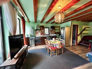 a kitchen with a table and a dining room at Lucas Duplex in Azuga