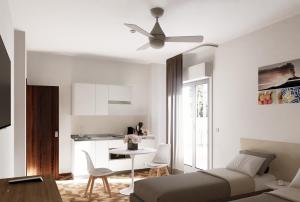a living room with a bed and a table and a kitchen at Residence Villa Giardini in Giardini Naxos