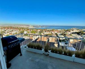 a balcony with a grill and a view of the ocean at Mod2bd2ba ShowstoprViews. BBQ. Garage. in San Pedro