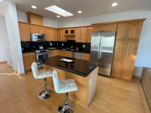 a kitchen with a black counter top and wooden cabinets at Mod2bd2ba ShowstoprViews. BBQ. Garage. in San Pedro
