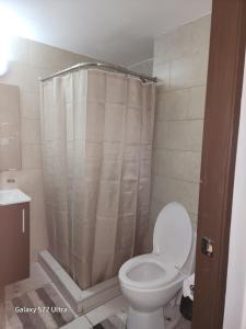 a bathroom with a toilet and a shower at Casa Hany in Panama City