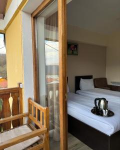 a room with a bed with a tea kettle on it at Verin Tun in Dilijan