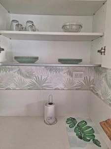 a kitchen with shelves with green and white wallpaper at Soñado MDQ in Mar del Plata