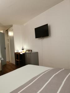 een kamer met een bed en een tv aan de muur bij Appart Hotel La Defense in Courbevoie
