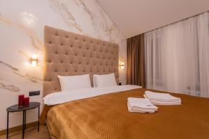 a hotel room with a large bed with towels on it at LUX Апартаменти MYFREEDOM поруч метро Театральна, Хрещатик in Kyiv +194 photos