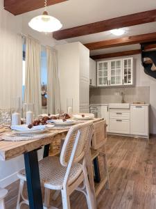 a kitchen with a wooden table with chairs and a dining room at Pine & Oak Holiday Home in Fužine