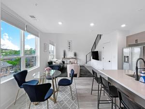 a kitchen and living room with a table and chairs at Mary's Stay Brookland in Washington, D.C.