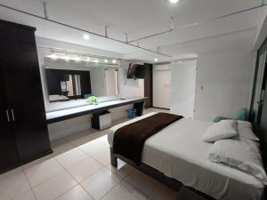 a bedroom with a large bed and a mirror at Giakor Suites - Gran Jardín in León