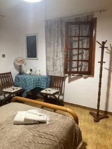a bedroom with a bed and a table and chairs at Apartment with Garden in Tragána