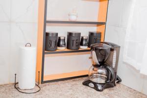 a blender sitting on a shelf in a kitchen at Davi Bliss in Oshakati +6 photos