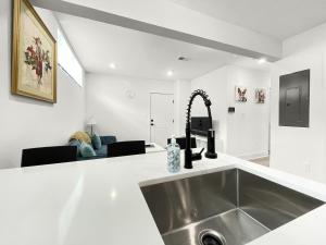 a kitchen with a stainless steel sink in a room at Mary's Stay Brookland in Washington, D.C. +253 photos