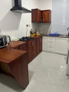 a kitchen with wooden cabinets and a counter top at OV HOMES in Dar es Salaam