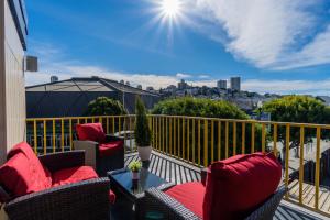 a balcony with chairs and a table on a balcony at The Wharf Inn in San Francisco