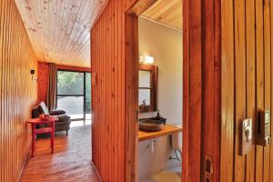 a hallway of a home with a wooden wall at Pousada Refúgio Araçá in Morro Redondo