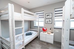 a bedroom with two bunk beds and a desk at Guesthouse Keflavik by Reykjavik Keflavik Airport in Keflavík