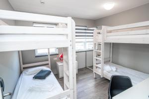 a room with two bunk beds and a desk at Guesthouse Keflavik by Reykjavik Keflavik Airport in Keflavík