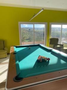 a living room with a pool table in a room at Vila GUŠT in Zlatibor