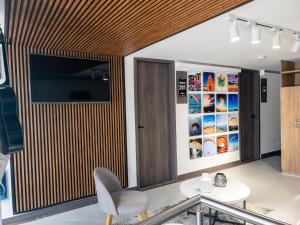 a room with a table and a tv on a wall at Hotel velero in Roldanillo
