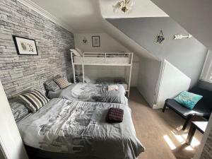 a bedroom with two bunk beds and a brick wall at THE EDINBURGH TOWNHOUSE - Boutique Hostel in Edinburgh