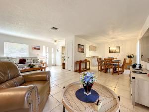 a living room with a couch and a table at Cozy home with 1-car garage within walking distance to the beach. 836C in New Smyrna Beach