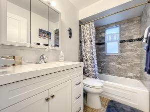 a white bathroom with a sink and a toilet at Cozy home with 1-car garage within walking distance to the beach. 836C in New Smyrna Beach +25 photos