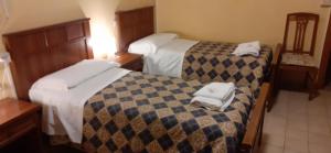 two beds in a hotel room with towels on them at Albergo Da Peppino in Poggio Mirteto