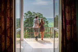 a man and a woman looking out of a window at 1886 Crescent Hotel and Spa in Eureka Springs