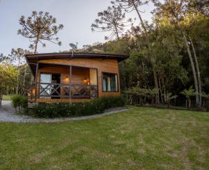 a small cabin in the middle of a grass field at La Bella Vista in Urubici